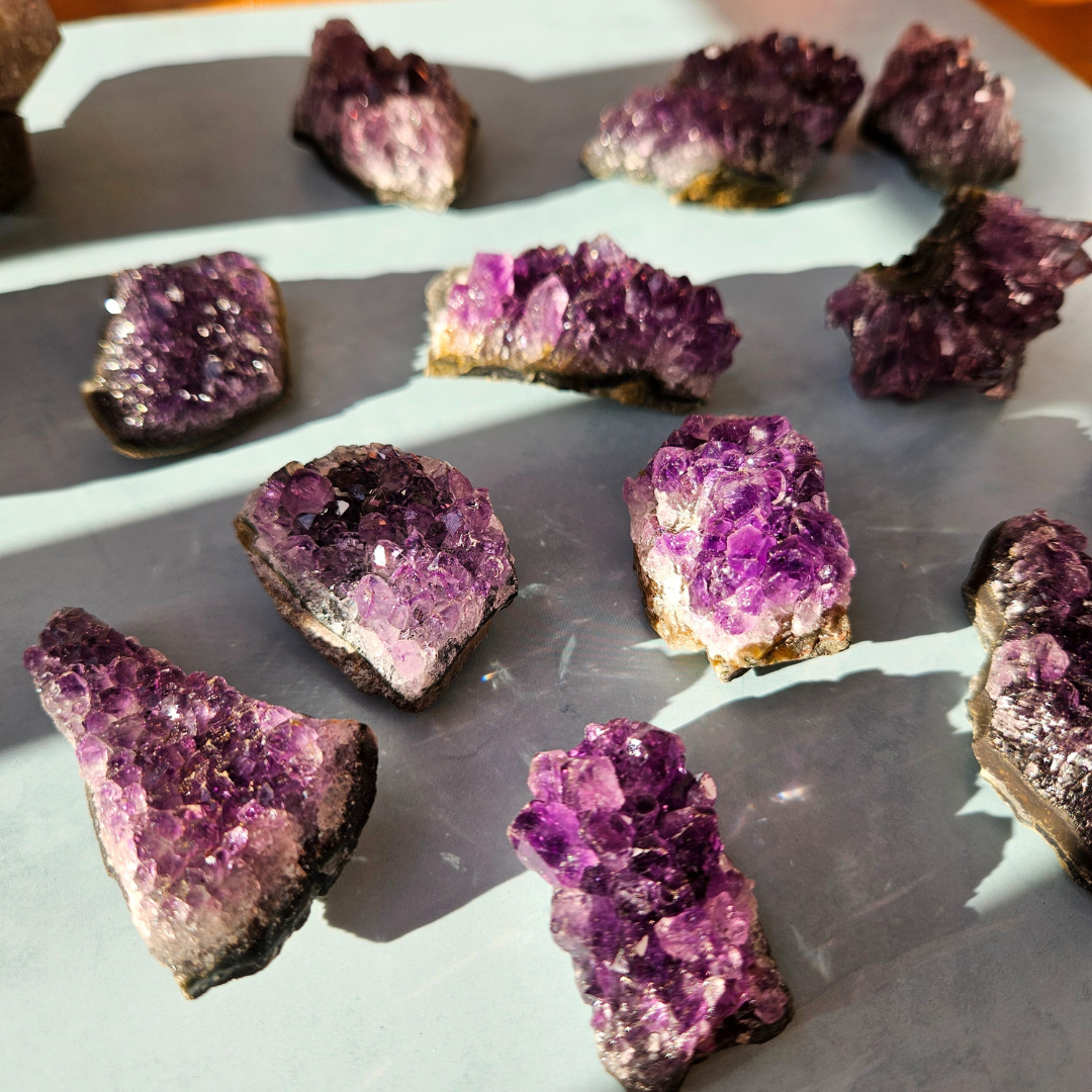 Amethyst crystal formations on a reflective surface